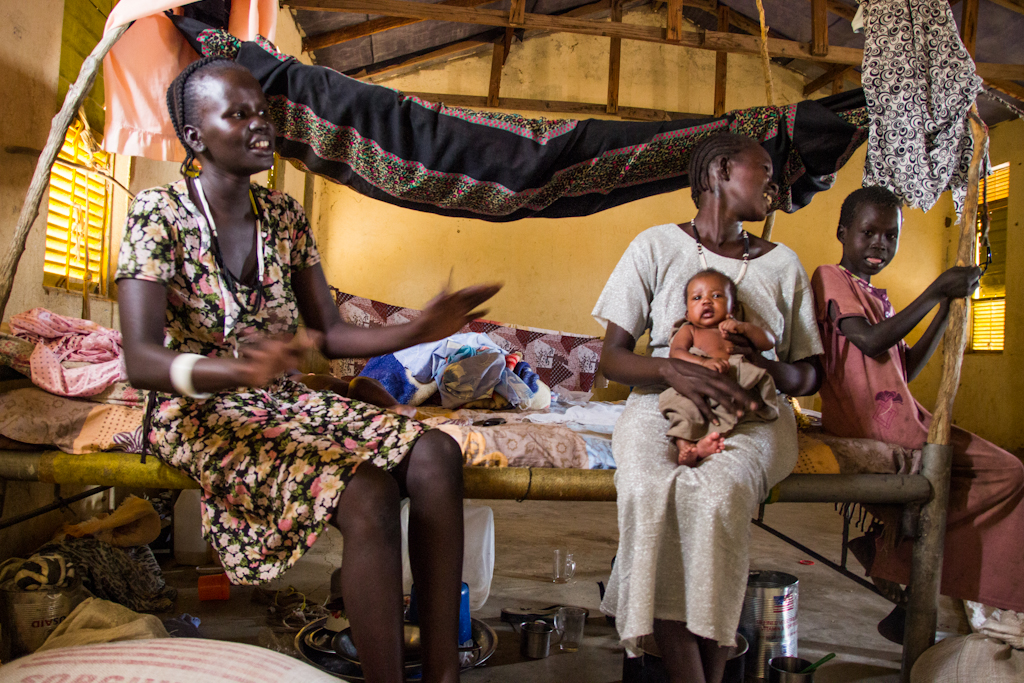 Mary and her newborn son sit inside a vacated school they now call home.