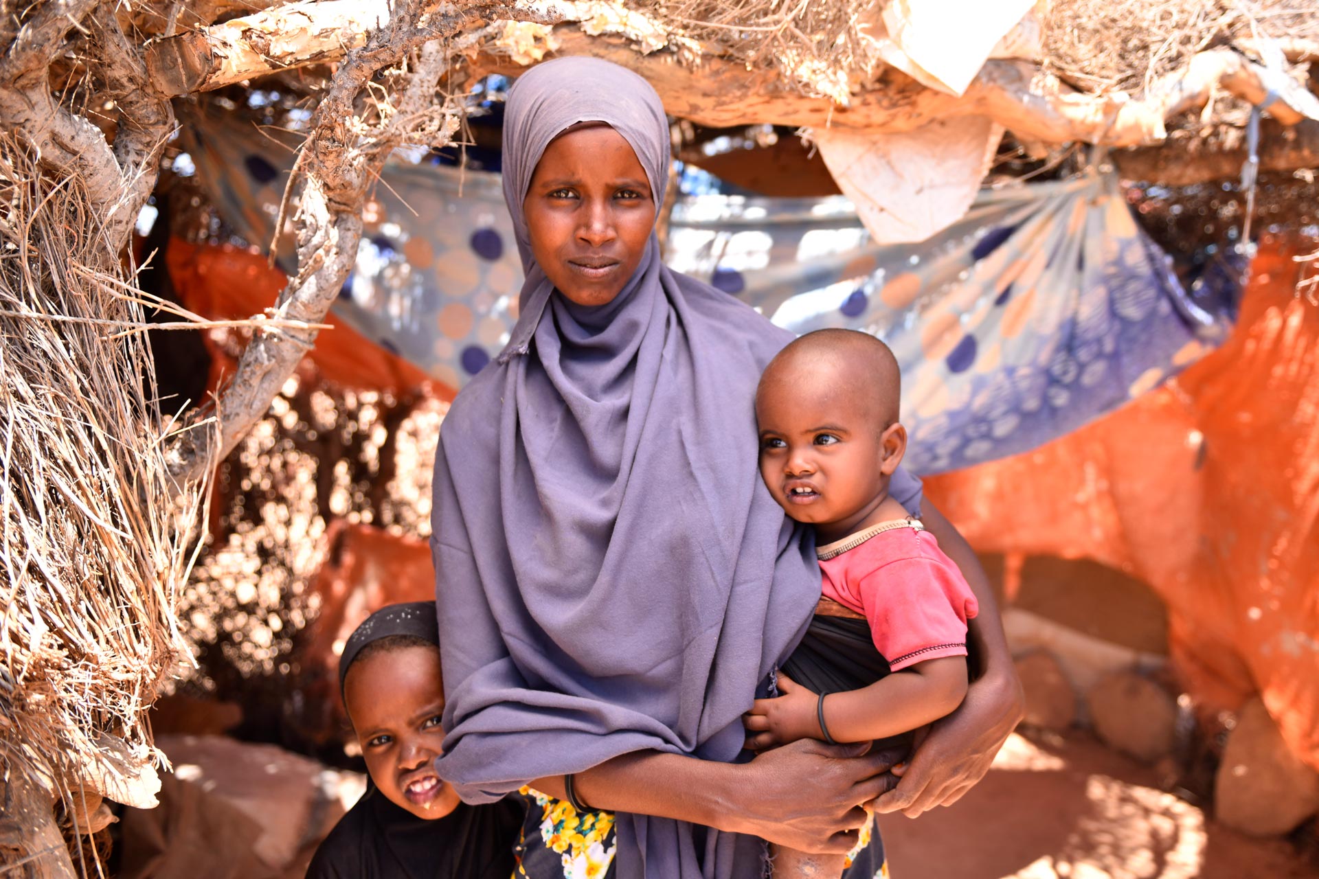 A mom in Somalia holds her child.
