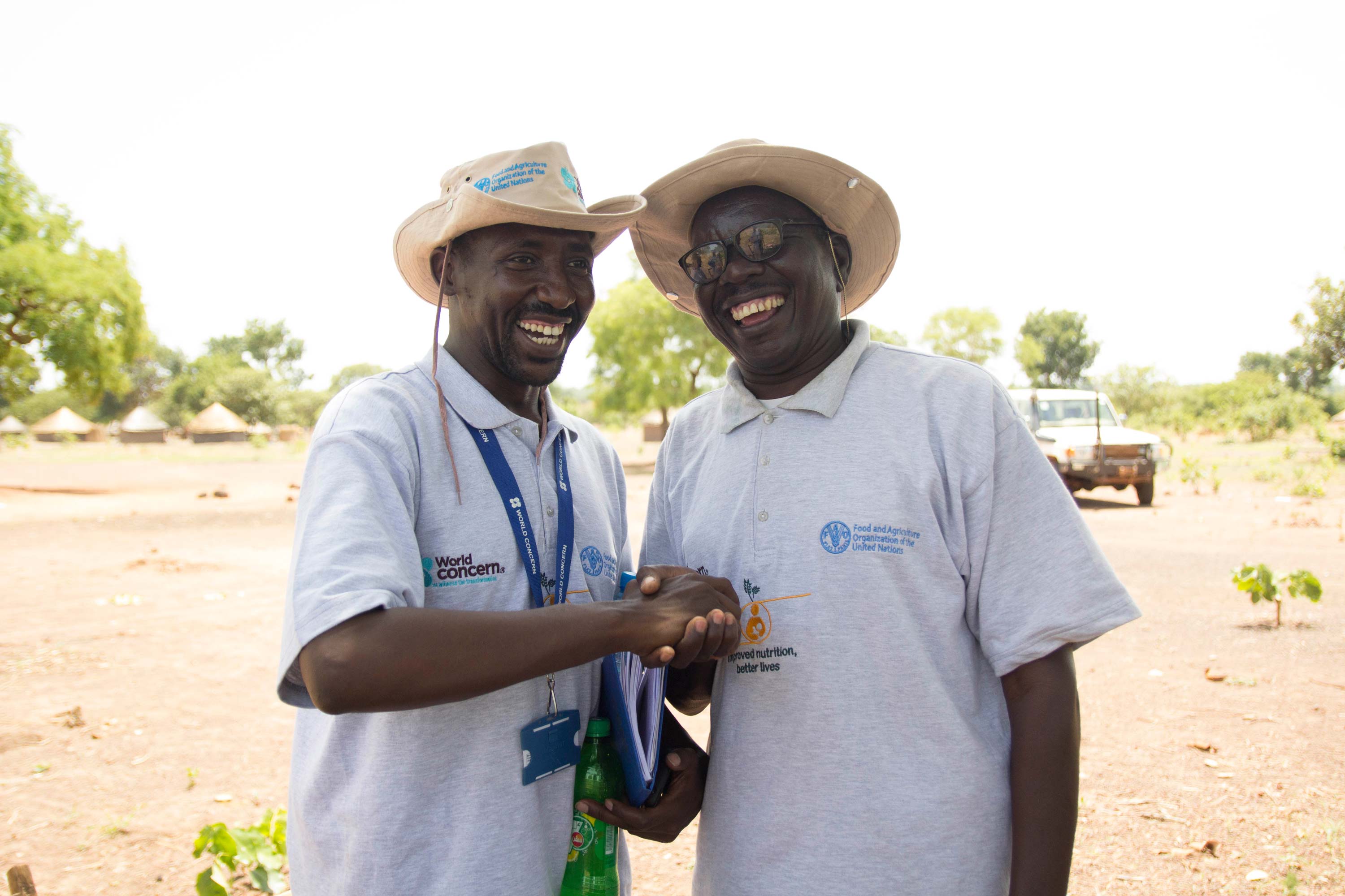 A World Concern staff member shakes hands with a partner
