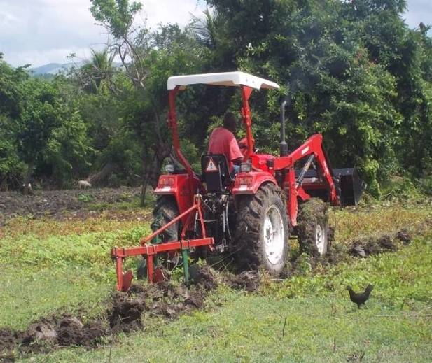 One of the project's tractors hard at work. The tractors are used to help local farmers during planting.
