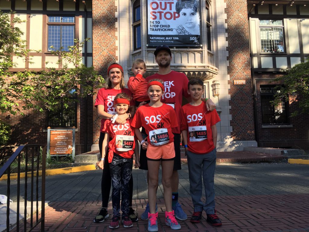 a family poses for a photo during a 5k race to stop child trafficking