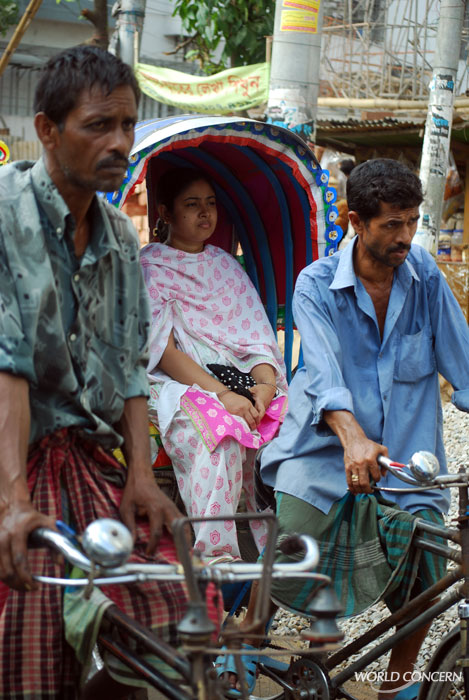 Men muscle 3-wheeled rickshaws through the streets of Dhaka, Bangladesh. The average income for a Bangladeshi: $1,500 a year.