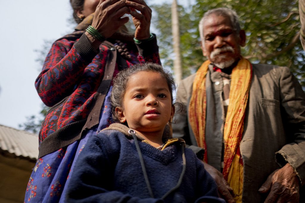 a little girl in Nepal is safe with her parents