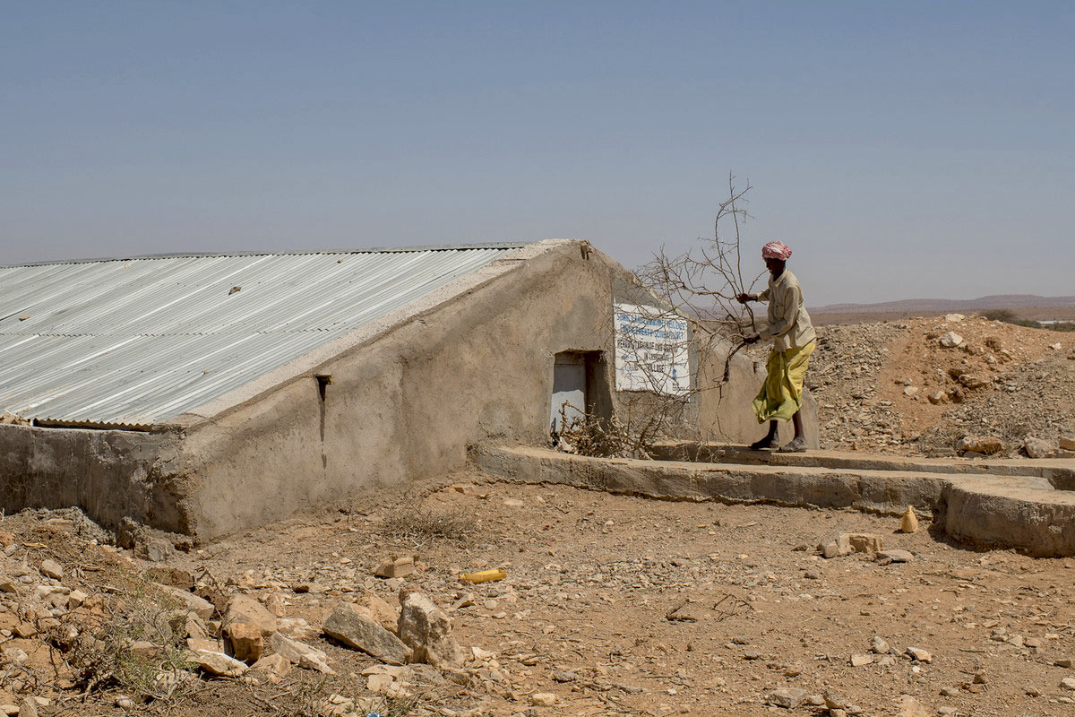 someone stands by a berkad that collects water in Somalia