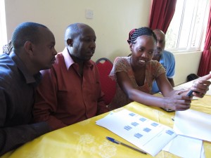 World Concern and partner agency staff practice scanning bar codes with their mobile phones during a training last week. 