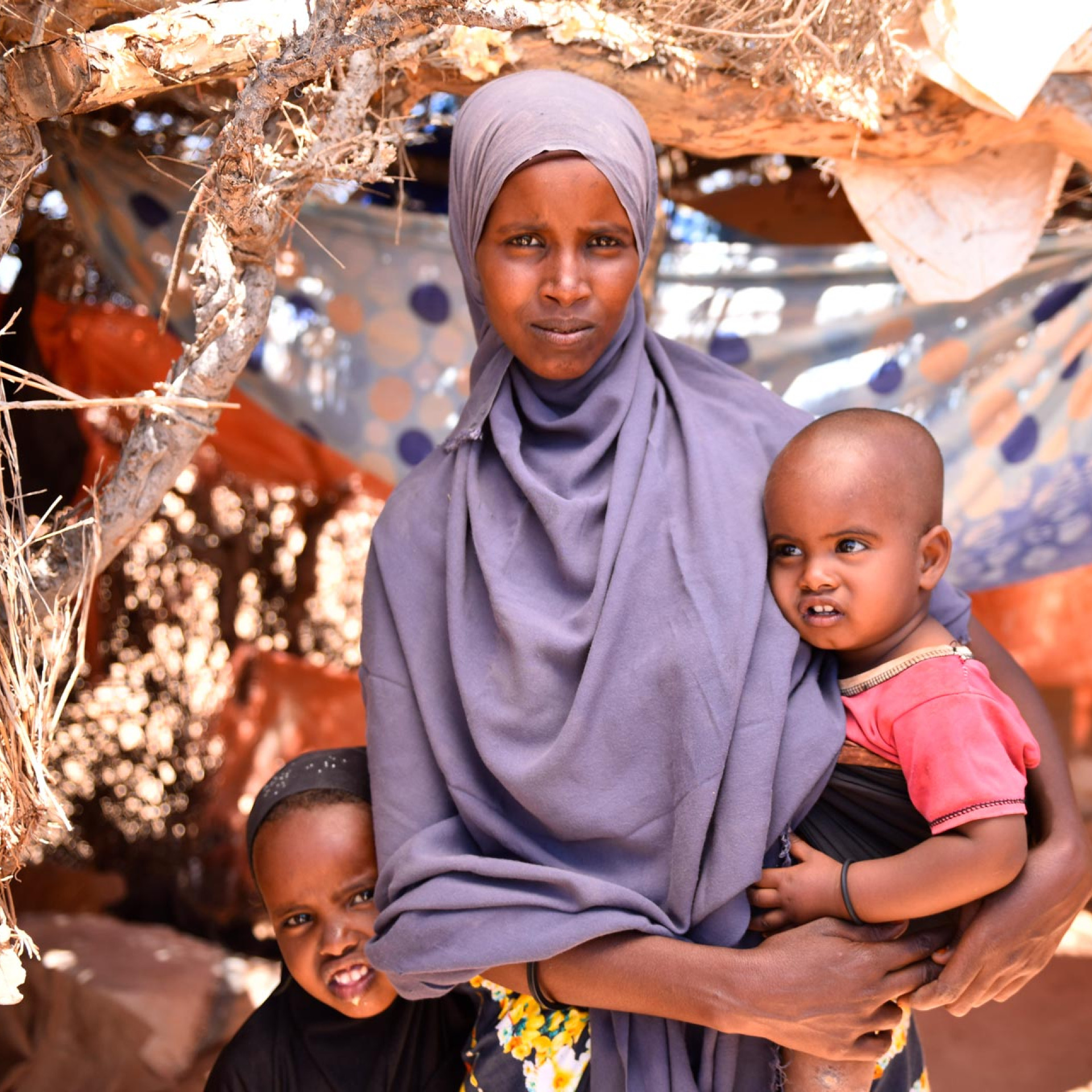 A mom in Somalia holds her child.