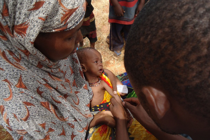 A World Concern staff member measures Baby Adey's tiny arm to determine her level of malnourishment.