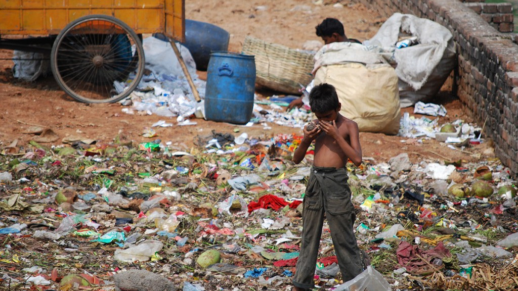 Boys foraging in garbage dump.