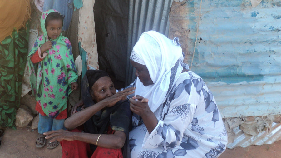 A World Concern staff member listens to the needs of an elderly muslim widow in Somalia.